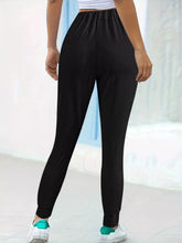 Black high-waisted casual pants with comfortable elastic waist and tapered legs ideal for everyday wear