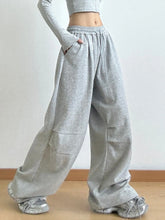 Gray heathered drawstring wide leg pants with elastic waistband and side pockets featuring comfortable wide leg fit