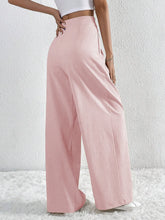 Soft pink v-waisted ruched front wide leg pants in subtle textured fabric high-waisted wide leg pants