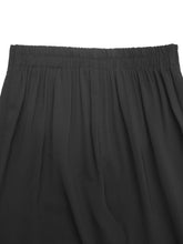 Black pleated skirt with elastic waistband complementing the floral lace hem wide leg pants design