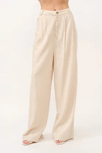 Beige high-rise wide leg linen blended pants with pleated front and gold-tone button closure for elegant wear
