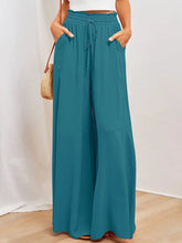 Teal wide leg pants with an elastic waistband drawstring and pockets for comfortable casual wear
