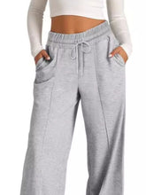 Gray heathered wide leg drawstring pants with elastic waistband and matching drawstring for comfortable wear