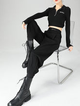 Black long-sleeved cropped polyester polo shirt with protect embroidery paired with high-waisted tapered pants