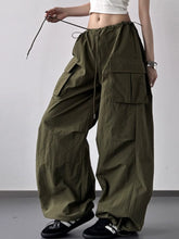 Olive green drawstring wide leg cargo pants featuring multiple large pockets and a comfortable wide leg fit
