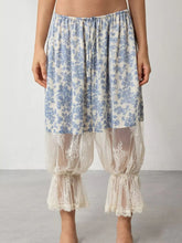 Blue and white floral lace patchwork pants with lace trim at the hem featuring a floral lace print design