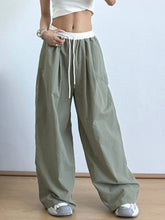 Olive green wide leg drawstring casual pants with white elastic waistband and matching drawstring for comfort