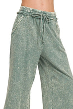 Moss green distressed cotton palazzo pants in washed french terry with elastic waistband and drawstring pockets