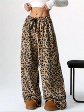 Beige and black leopard print wide leg plush pants with a drawstring waist for comfortable casual wear
