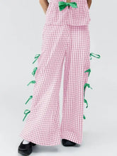 Pink and white checkered pants with green ribbon accents in clothing set