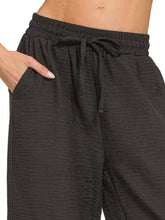 Black textured woven crepe elastic band pants by zenana with elastic waistband and drawstring for casual wear