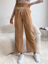 Beige wide leg drawstring casual pants with elastic waistband and white drawstring for comfortable wear