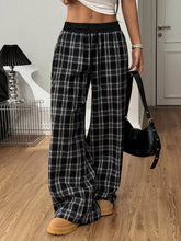 Black and white plaid wide-leg pants with elastic waistband designed for comfortable casual wear