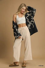 Cream-colored Umgee wide leg pants with a drawstring waistband made from soft breathable fabric