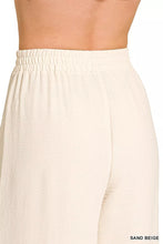Cream-colored loose-fitting zenana woven airflow pants with elastic waistband and subtle textured fabric