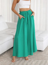 Emerald green wide leg pants with high waist drawstring and side pockets for comfortable stylish wear