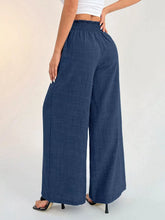 Navy blue wide leg pants with elastic waist wide design and subtle textured fabric for comfortable wear
