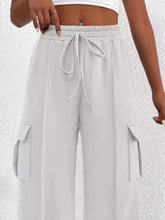 Light gray casual high waist cargo pants with drawstring waistband and large side pockets for versatile wear