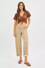 Brown ribbed crop top with puffed sleeves and front tie detail paired with risen high rise crop barrel corduroy pants
