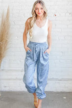 Light blue satin leopard print joggers with elastic waistband machine wash cold and subtle leopard print pattern
