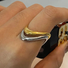 18k gold-plated and stainless steel wave ring on finger
