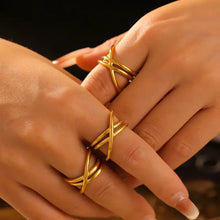 Two hands with 18K gold-plated crisscross rings