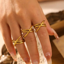 Three 18K gold-plated crisscross rings on fingers