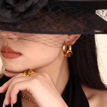 Elegant woman in veiled hat wearing 18k gold-plated tiger’s eye earrings