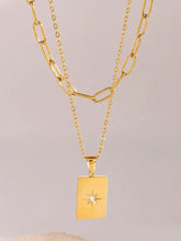 18k gold-plated layered necklace with starburst pendant and stainless steel extension
