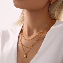 Layered 18k gold-plated shell pearl necklace with sunburst pendant and hoop earrings