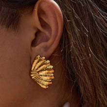 18K gold-plated shell stud earring on ear