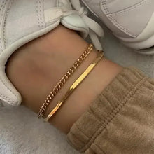 Two layered 18k gold-plated anklets in stainless steel on ankle
