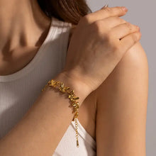 Gold-colored bracelet with butterfly links on wrist, featured in 18K Gold-Plated Butterfly Bracelet product