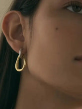 18K gold-plated steel contrast asymmetrical earring on ear