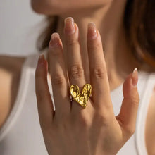 Womans hand with 18k gold-plated heart ring