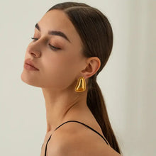 Woman wearing 18k gold-plated stainless steel stud earrings