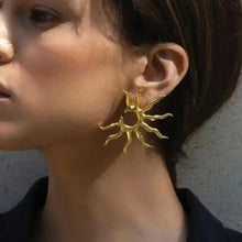 Golden sun ray earrings in 18K gold-plated jewelry on ear