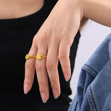 Hand wearing two 18k gold-plated sun rings on titanium steel