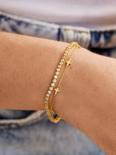Armband aus titanbeschichtetem Stahl mit 18 Karat Gold, goldenen Sternperlen, Diamantakzenten und Herzanhängern