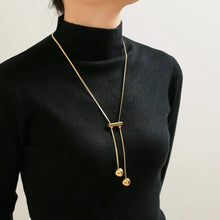 18k gold-plated titanium steel hollow bead lariat necklace on black turtleneck