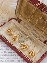 Four 18k gold-plated titanium steel hoop pendant necklaces with intertwined rings