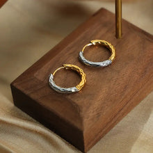 18k gold-plated titanium steel two-tone hammered huggie earrings on wooden stand