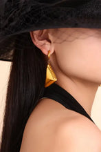18K gold-plated triangle dangle earring on woman’s ear