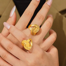 Two intertwined 18K gold-plated twisted rings on fingers