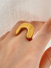 Shiny 18K gold-plated stainless steel U-shaped ring on finger