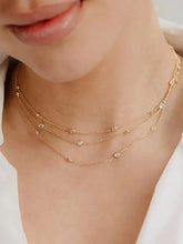 Three delicate 18K gold-plated inlaid zircon layered necklaces with diamond accents