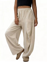Plus size relaxed fit beige wide-leg pants with elastic waistband and side pockets for casual wear
