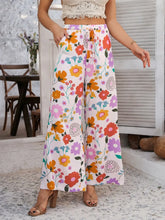 Devine drawstring printed wide leg pants with vibrant orange pink purple and yellow floral print on white fabric and care instructions