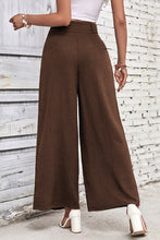 Brown high waisted wide leg pants in subtle textured fabric ideal for stylish and comfortable wear