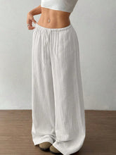 White wide leg drawstring casual pants made of textured lightweight fabric with elastic waistband for comfort
